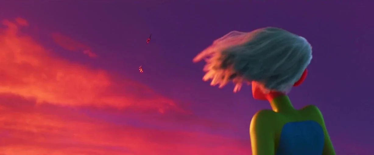 Incredibles 2 (2018) movie still: medium — A character with green skin and short light hair stands against a vibrant sunset. They gaze upward at two…