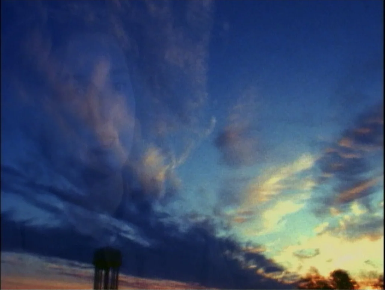 America Undercover: Life Afterlife (2000) movie still: establishing — A vast sky at dusk with dark clouds transitioning into a warm golden sunset. A…