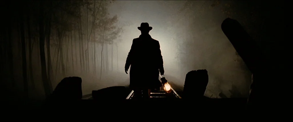 The Assassination Of Jesse James By The Coward Robert Ford (2007) movie still: fullbody — A man walks away along a narrow railway track through a…