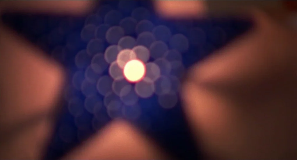 The Heart Is Deceitful Above All Things (2004) movie still: closeup — A dark abstract field contains a single central white light point. A…