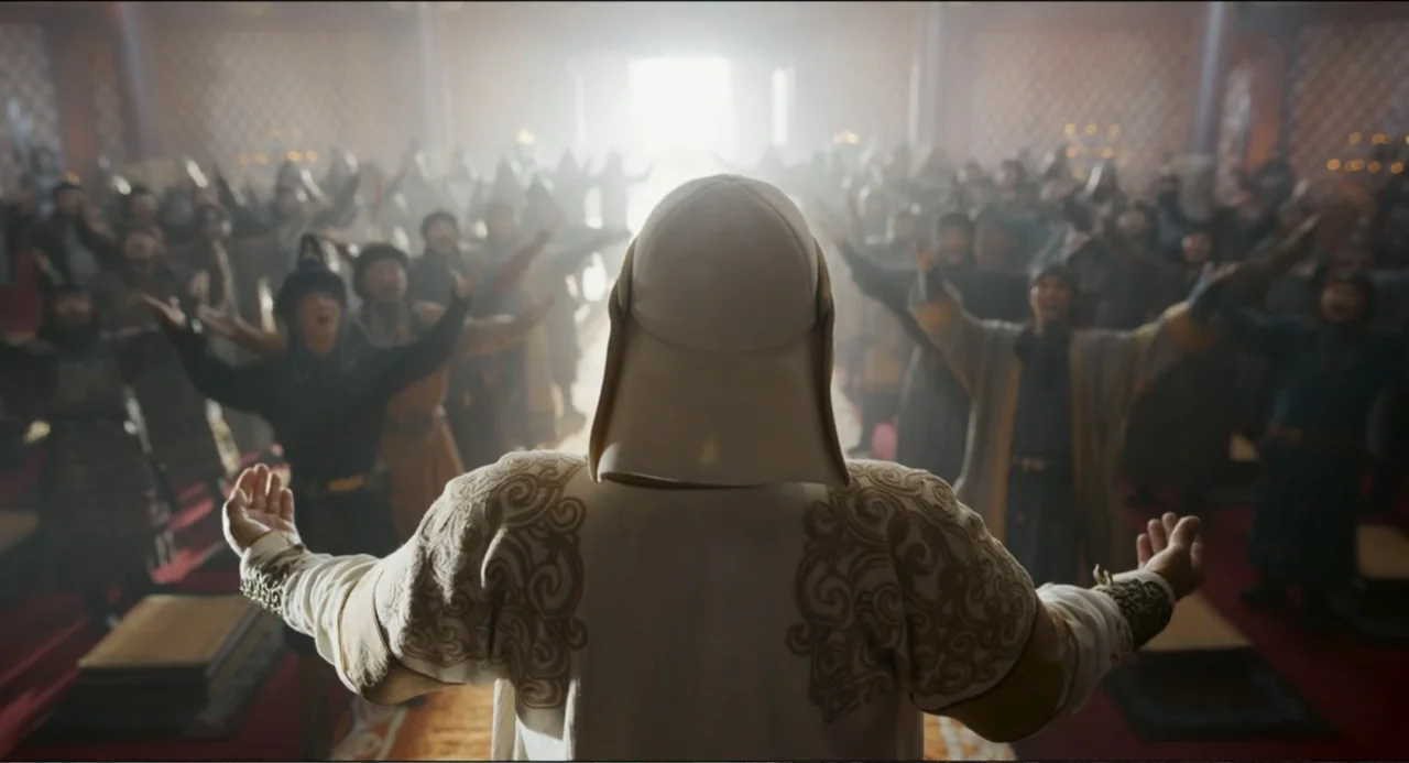 Legends of the Condor Heroes: The Gallants (2025) movie still: medium — A spacious hall with tall columns and a crowd gathered in the background. A…