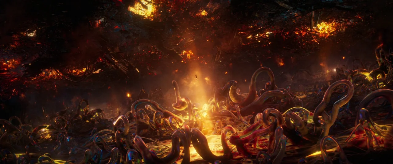 Ant-Man and the Wasp: Quantumania (2023) movie still: wide — An alien landscape features dark, twisted, tentacle-like organic growths covering the…