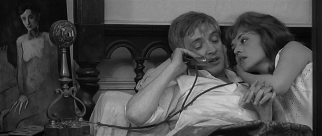 Jules and Jim (1962) movie still: medium — An interior bedroom space features an antique telephone and an impressionistic painting in the…