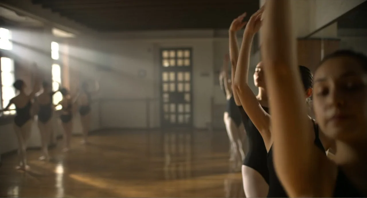 Heartbeat (2008) movie still: medium — A spacious dance studio features hardwood floors and large windows along one wall. Several ballerinas in…