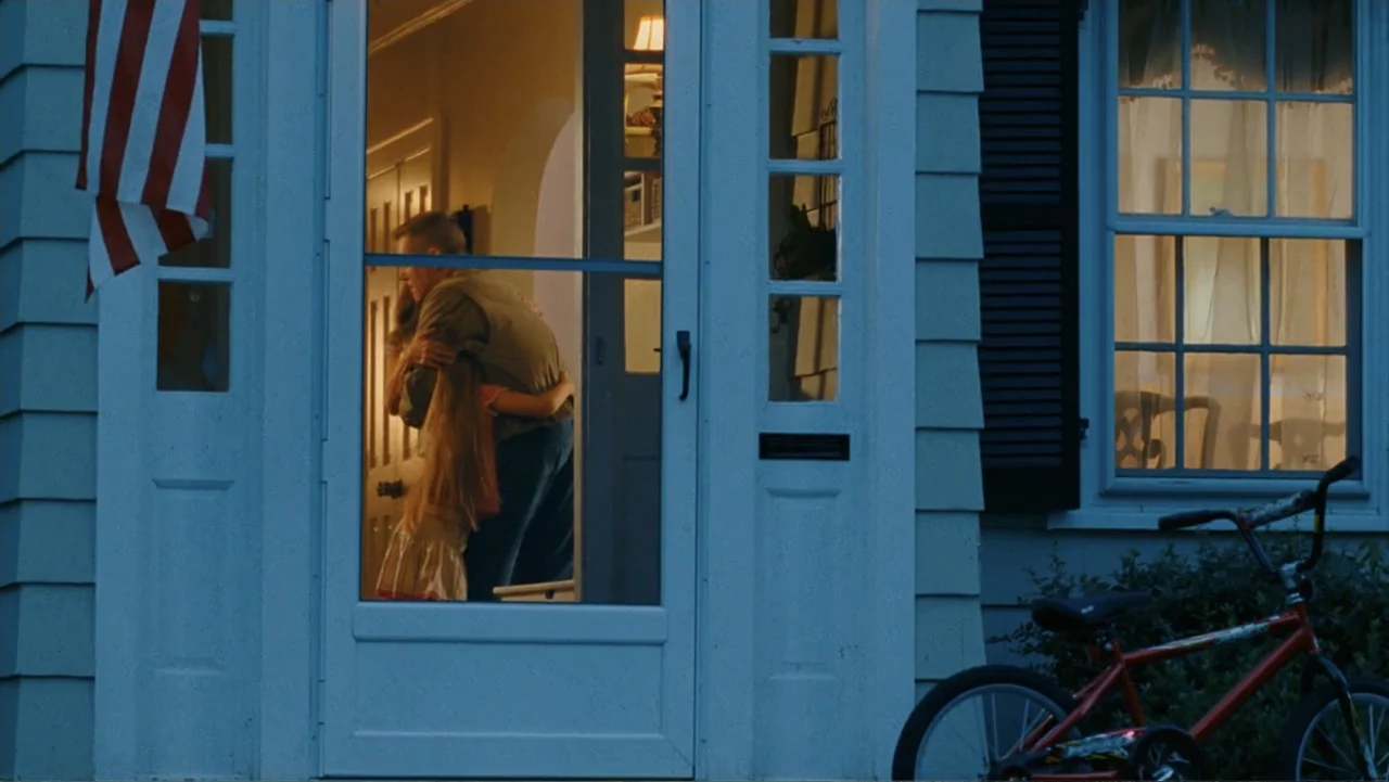 Taking Chances (2011) movie still: medium — A white front door with glass panels sits in a house frame at dusk. A man and a young girl stand behind…
