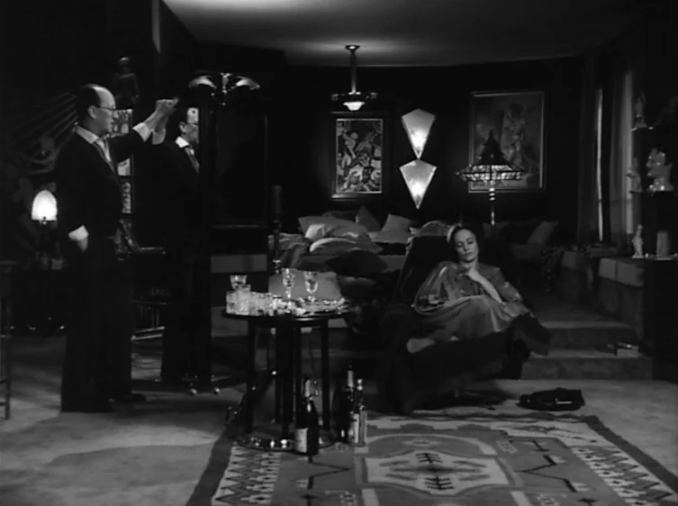 From the Life of the Marionettes (1980) movie still: wide — A dark, modern luxury apartment interior is decorated with geometric wall sconces and…