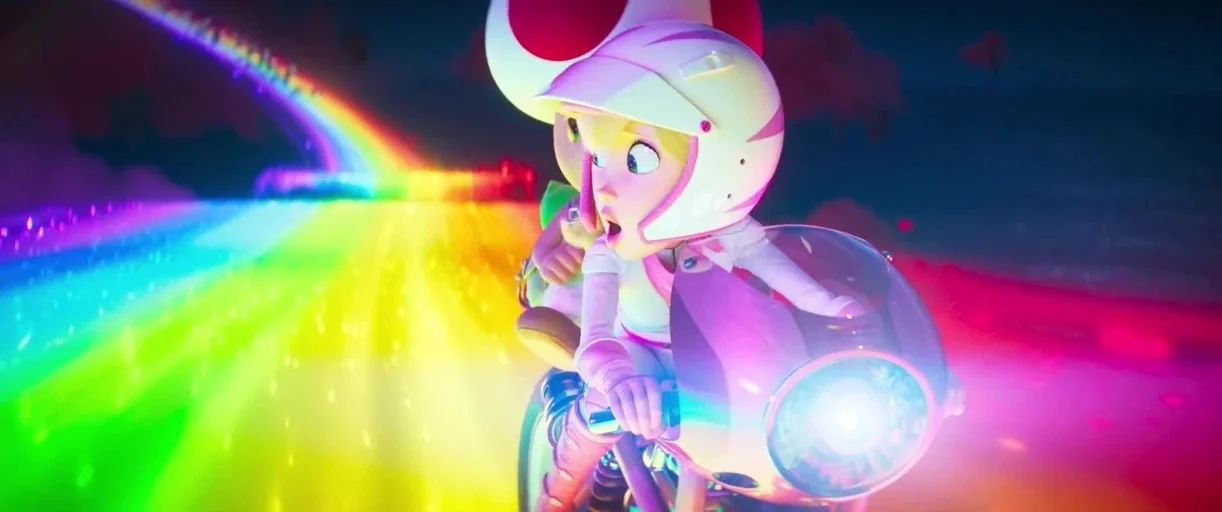 The Super Mario Bros. Movie (2023) movie still: medium — A neon rainbow path cuts through a dark, surreal environment at high speed. A human woman…