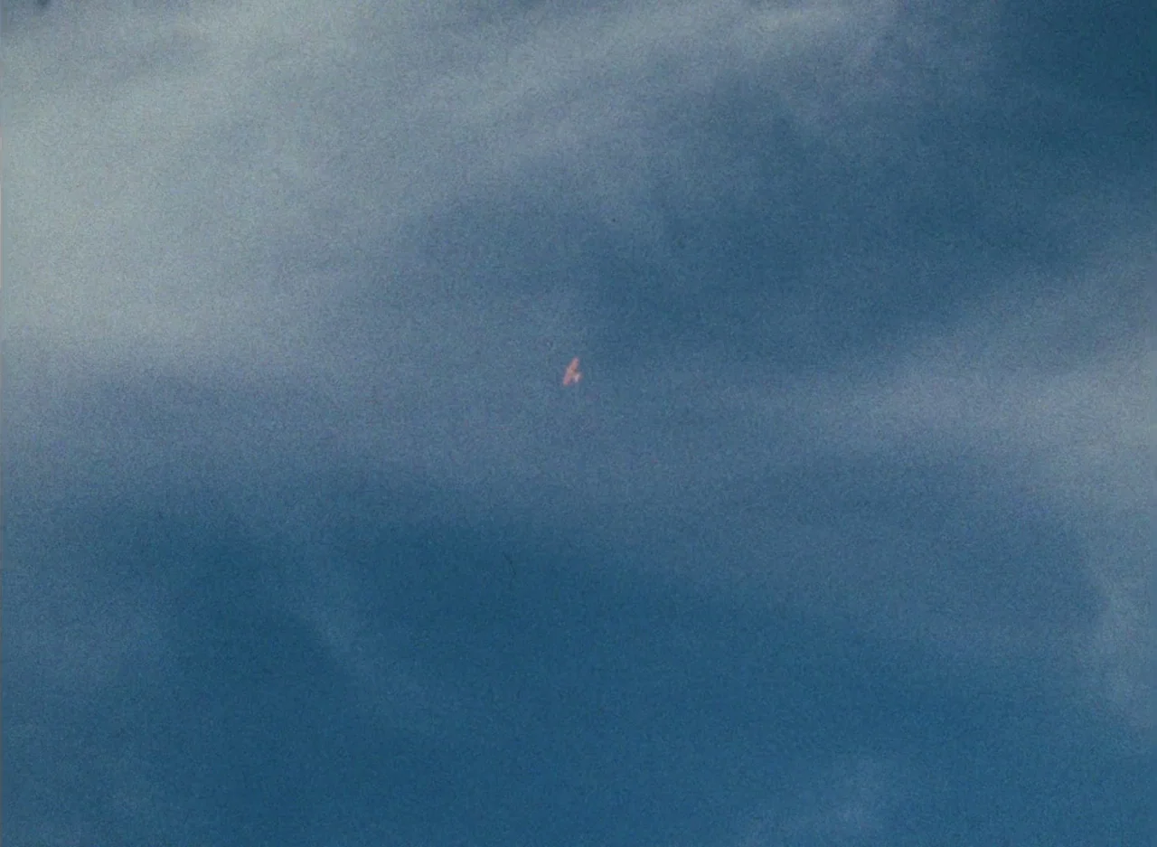 Wanda (1970) movie still: establishing — A vast expanse of blue cloudy sky dominates the entire frame. A singular distant object appears as a small…
