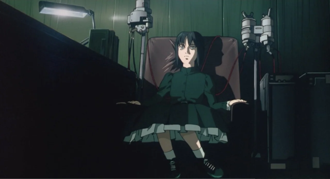 Ghost in the Shell (1995) movie still: medium — A dark laboratory interior with green walls features complex medical machinery and equipment. A…