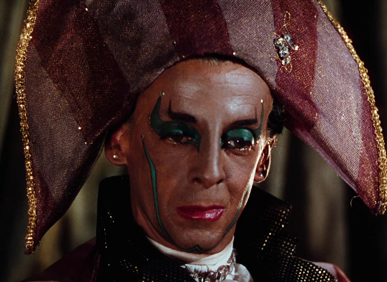 The Tales of Hoffmann (1951) movie still: closeup — A close-up shot of a person in elaborate, textured stage costume and makeup. The subject is…