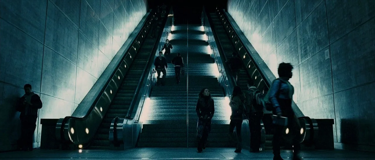 The Midnight Meat Train (2008) movie still: wide — A modern subway station features long escalators flanked by grey concrete panelled walls.…