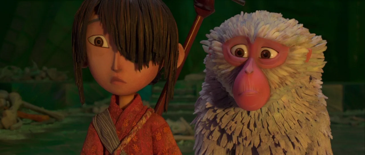 Kubo and the Two Strings movie still: medium — A dark, ancient stone chamber filled with scattered debris and a greenish ambient glow. A young boy…