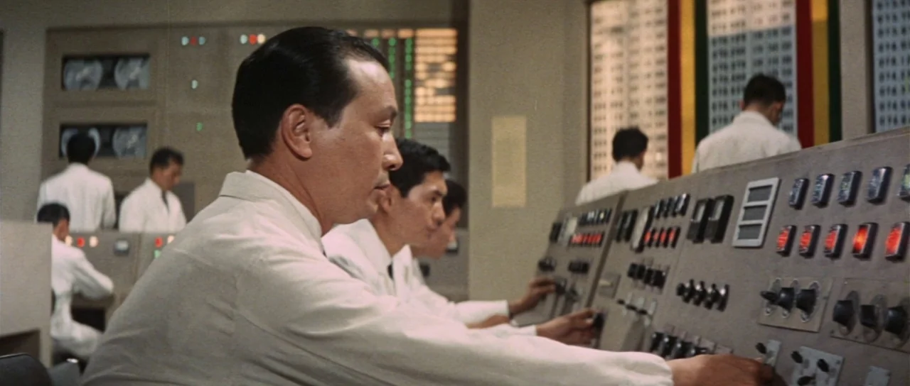 Invasion of Astro Monster (1965) movie still: medium — An orderly control room features technicians in white uniforms operating large electronic…