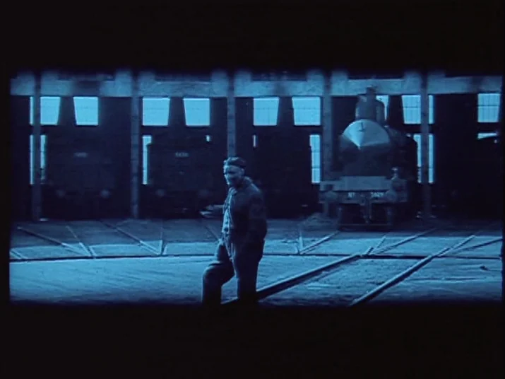 Making of: The Wheel (La Roue) (1923) movie still: fullbody — A spacious industrial locomotive shed features radial tracks leading into large…