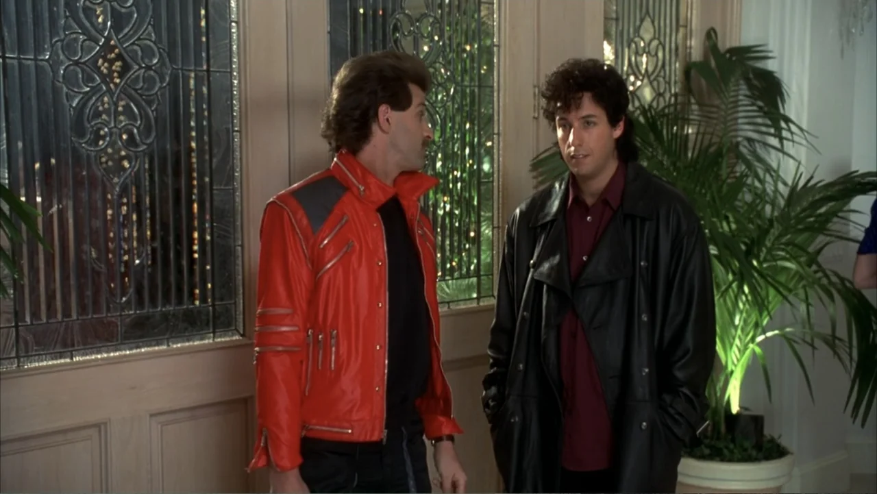 The Wedding Singer (1998) movie still: medium — A well-lit residential foyer features leaded glass doors and a large potted plant. Two men stand in…