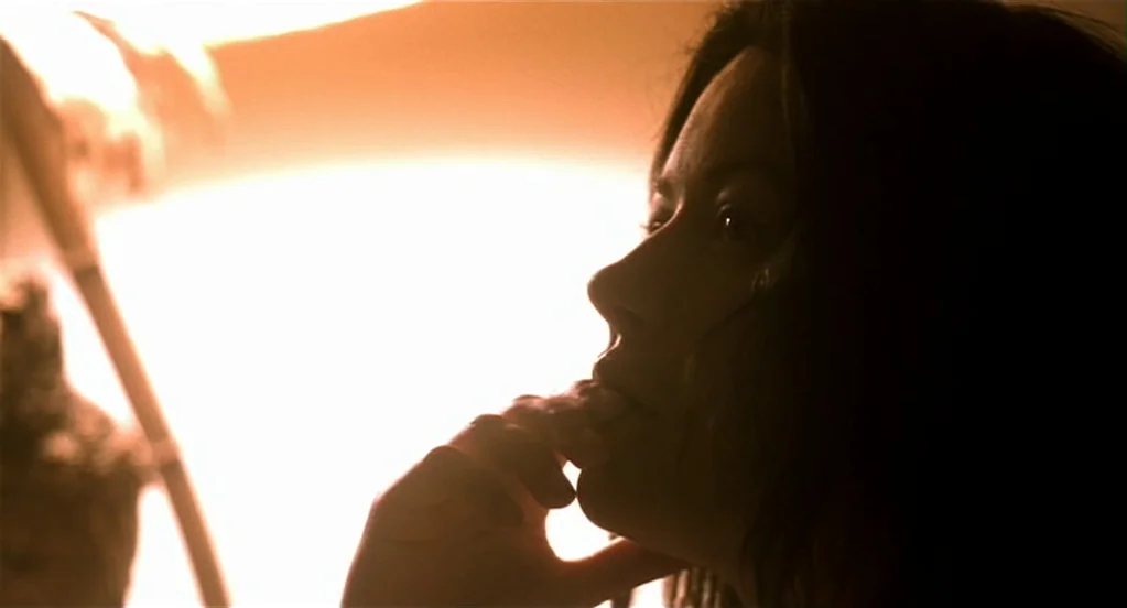 Traffic (2000) movie still: closeup — An interior space is dominated by an intensely bright, overexposed light source. A woman's silhouette is…