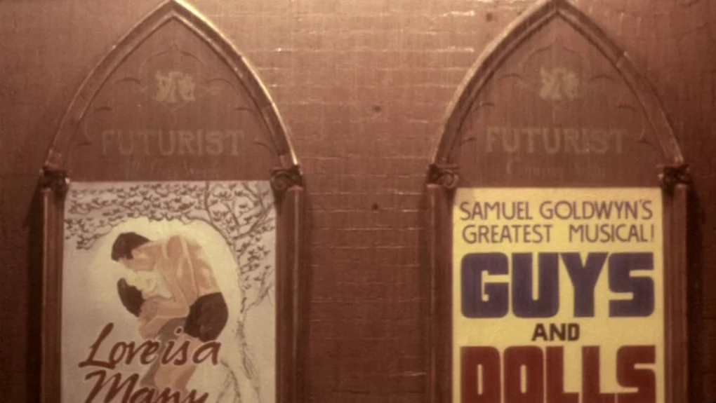 Distant Voices, Still Lives (1988) movie still: establishing — Two framed, arched movie posters for 1950s films are hung side by side. The posters…