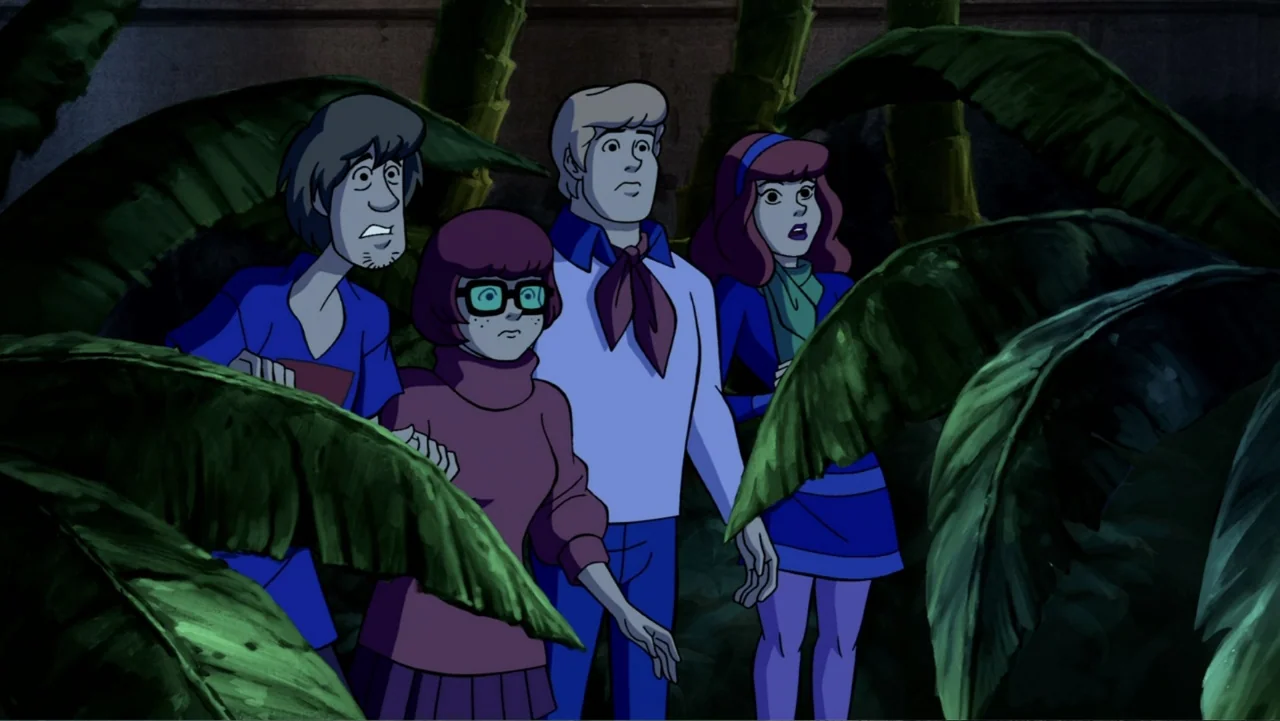 Scooby-Doo! Mask of the Blue Falcon (2012) movie still: medium — Four cartoon teenagers stand within a dense thicket of oversized dark tropical…