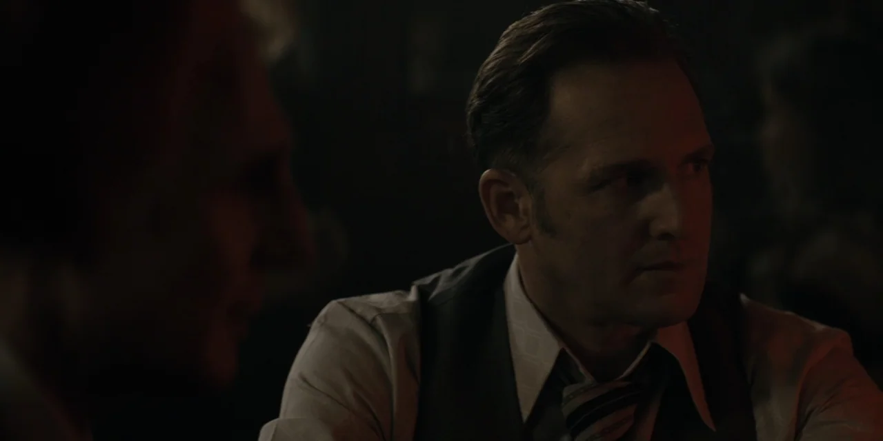 Mark Felt: The Man Who Brought Down the White House (2017) movie still: medium — A dimly lit room with dark wooden textures visible in the…