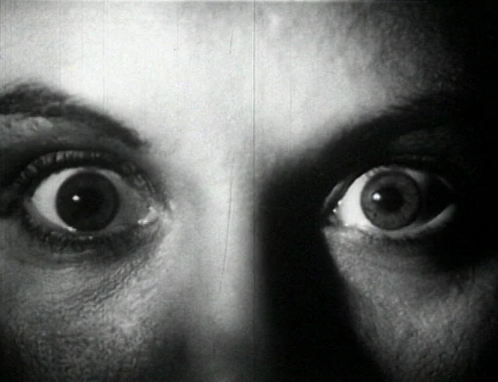 Dementia (Daughter of Horror) (1955) movie still: closeup — A close-up view of a person's eyes against a dark, featureless backdrop. The eyes are…