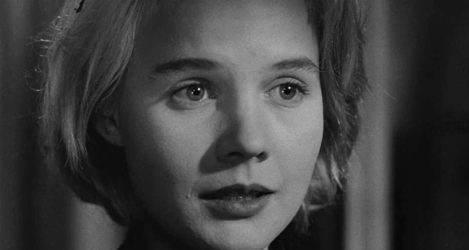Baby Doll (1956) movie still: closeup — A close-up of a young woman's face against a neutral indoor background. She looks slightly to the side with…