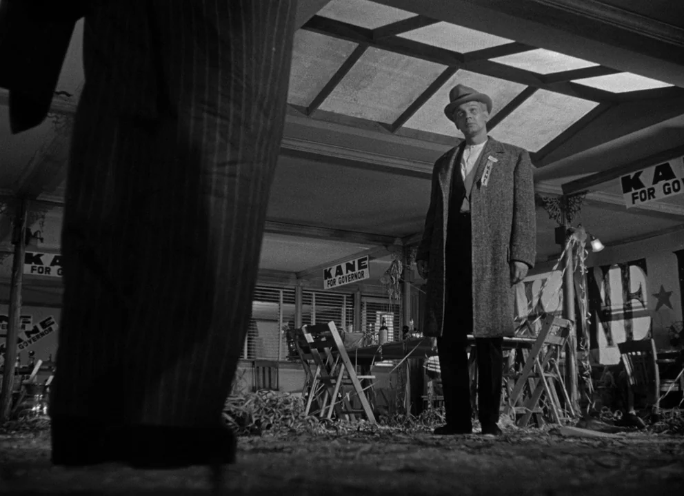 Citizen Kane (1941) movie still: fullbody — A cluttered campaign office with political posters scattered on the floor and tables. A man in an…
