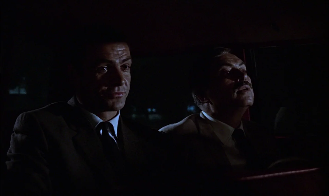 From Russia With Love (1963) movie still: medium — A dark car interior at night with two men sitting in the front seats. The two men sit…