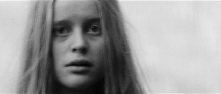 Marketa Lazarová (1967) movie still: closeup — An outdoor, out-of-focus setting with overcast lighting conditions. A young woman with long hair…
