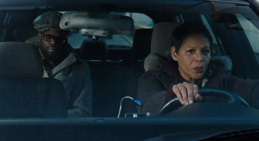 35 Shots of Rum (2008) movie still: medium — A woman drives a car with a man sitting in the passenger seat. Both look forward from inside the vehicle.