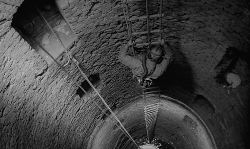Love Affair, or the Case of the Missing Switchboard Operator (1967) movie still: fullbody — A narrow, cylindrical stone well descends into darkness.…