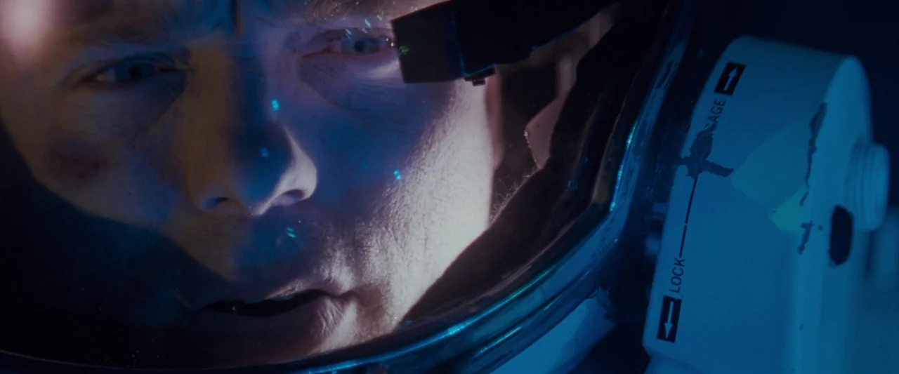 The Abyss (1989) movie still: closeup — Close interior view of an astronaut inside a pressurized helmet within a dark environment. The astronaut…