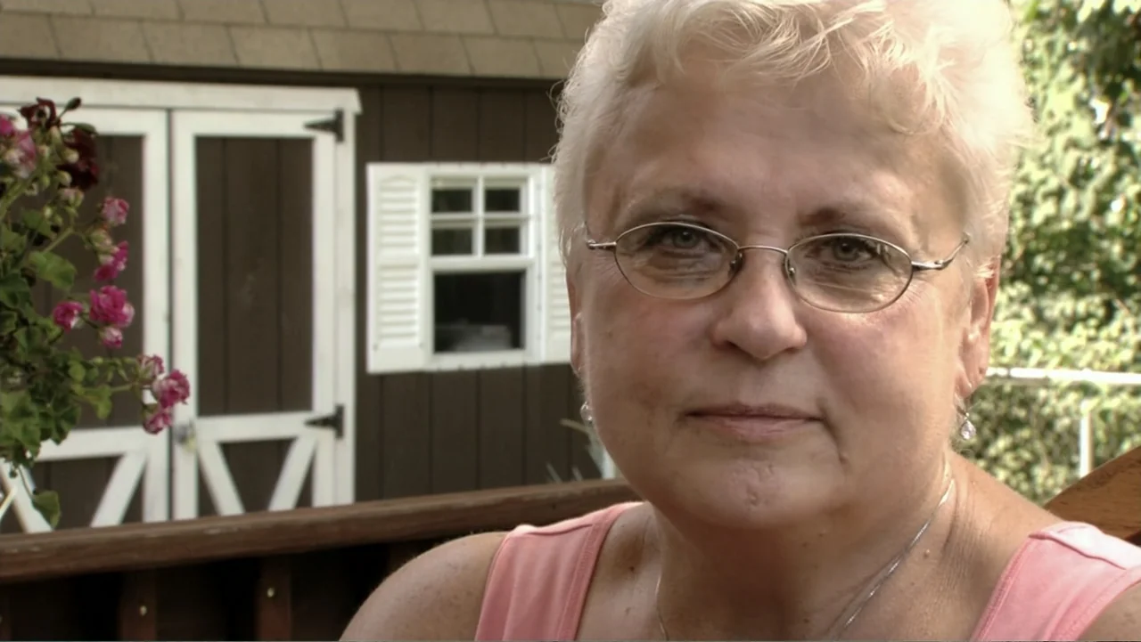 When Strangers Click: Five Stories from the Internet (2011) movie still: closeup — An outdoor backyard deck with a dark brown storage shed in the…