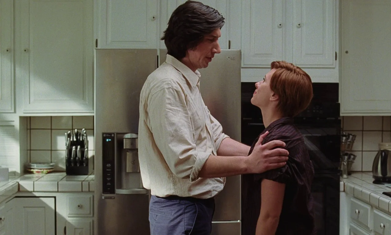 Marriage Story movie still: medium — A residential kitchen features white cabinetry, tiled countertops, and a modern stainless steel refrigerator. A…