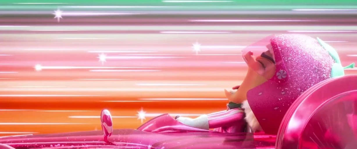 Ralph Breaks the Internet (2018) movie still: medium — A character drives a pink race car on a blurry, colorful track. The driver wears a sparkling…