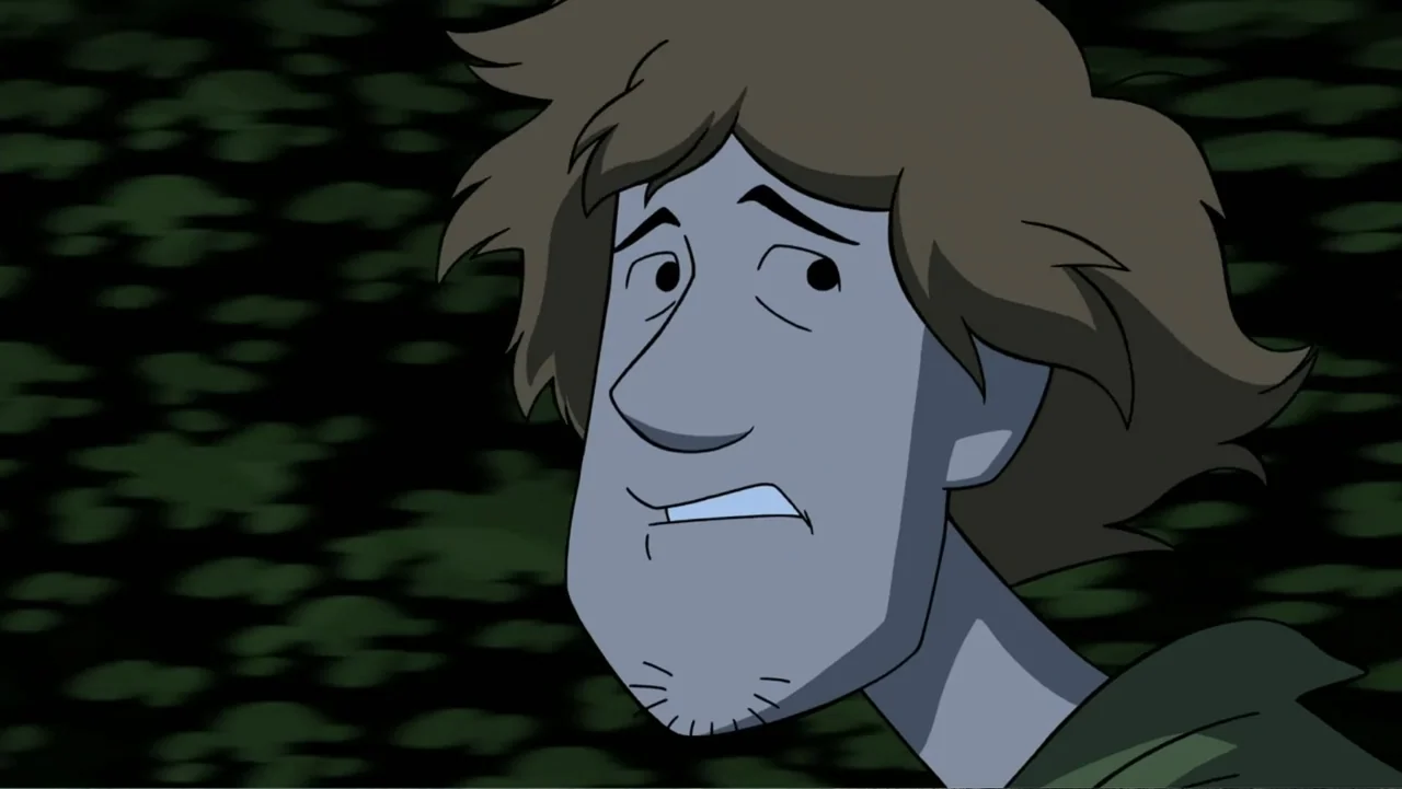 Scooby-Doo! and the Gourmet Ghost (2018) movie still: closeup — A dark, out-of-focus forest setting at night with dense foliage in the background. A…