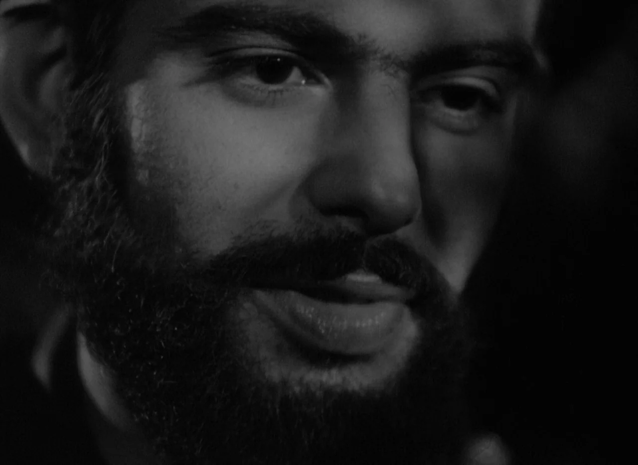 At Midnight I’ll Take Your Soul (1964) movie still: closeup — A dark, nondescript interior space surrounds a man seen in extreme close-up. The man…