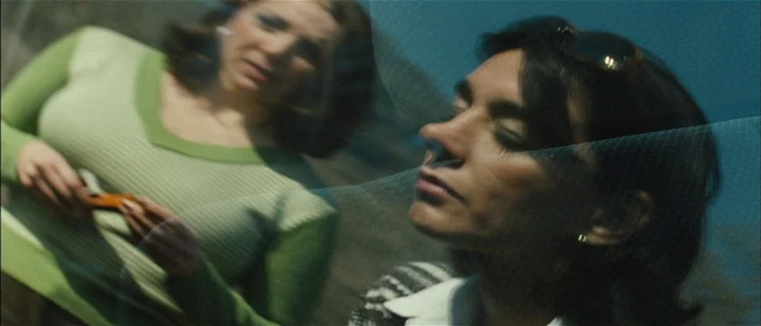 The Headless Woman (2008) movie still: closeup — Two women appear superimposed over each other through a reflective car window surface. One woman's…