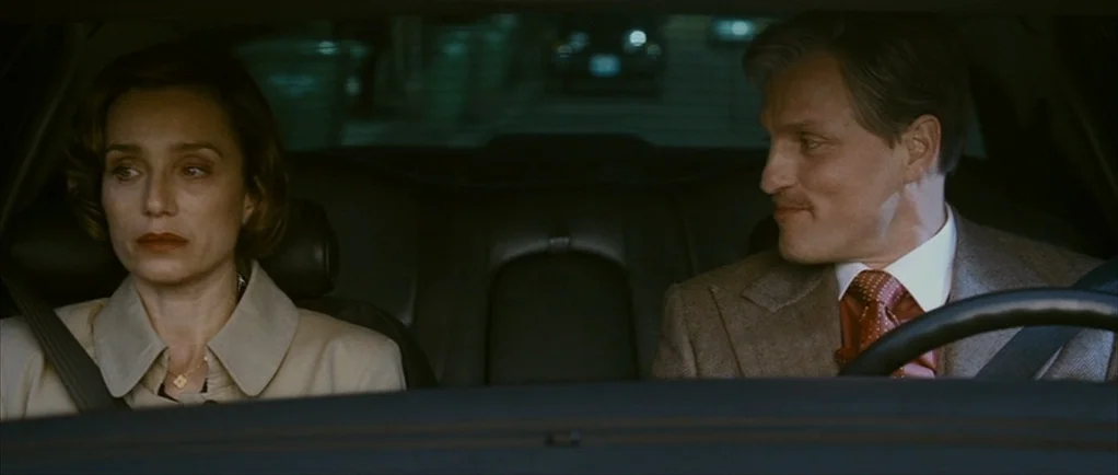The Walker (2007) movie still: medium — A dark vehicle interior with the two passengers silhouetted against a dim city night. The man in the driver…