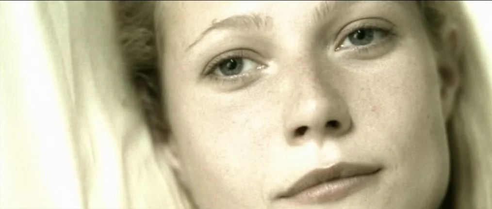 Se7en (1995) movie still: closeup — A close view of a face resting against soft white fabric. The light is diffused across the skin surface.