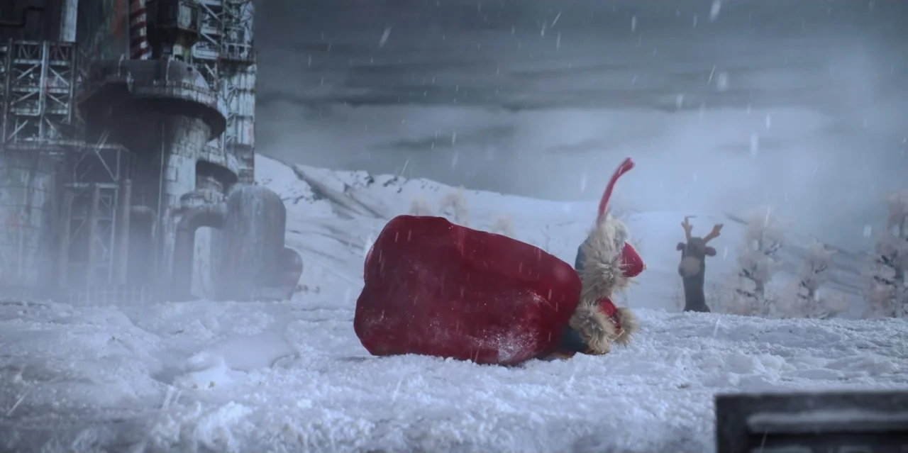 31 Minutes: One Hot Christmas (2025) movie still: wide — A snowy, desolate tundra contains a weathered industrial complex with tall metallic pipes.…