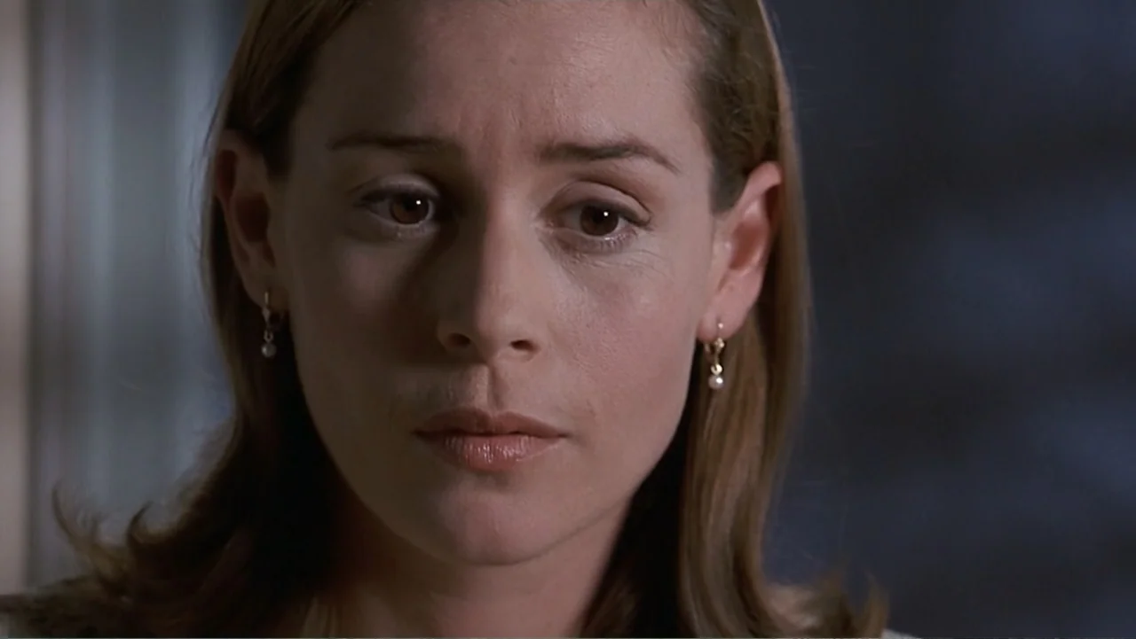 Matilda (1996) movie still: closeup — A dimly lit room provides the backdrop for the close-up portrait. A woman faces the camera directly while…