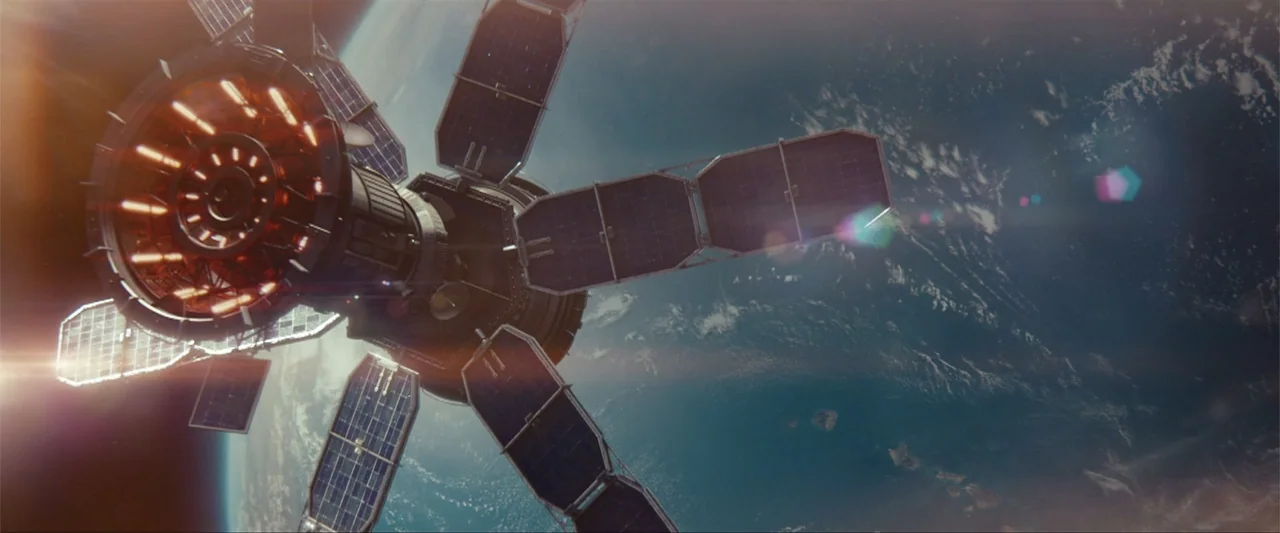 Battleship (2012) movie still: establishing — A detailed satellite orbits above the curved surface of the Earth in deep space. Glowing orange lights…