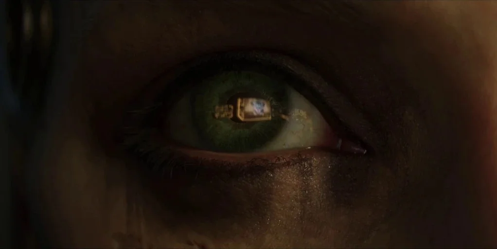 Love, Death & Robots (2019) movie still: closeup — A dark space serves as the setting for this extreme close up shot. A human eye reflects a glowing…