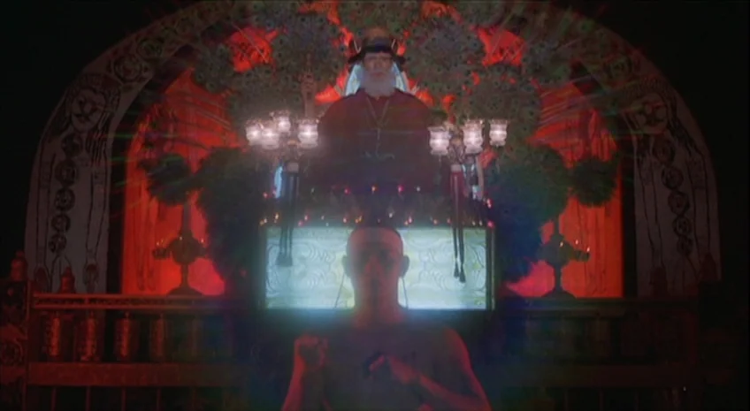 Boxer’s Omen (Mo) (1983) movie still: medium — An ornate red-lit shrine contains a central altar with a seated man in robes. A bare-chested man…