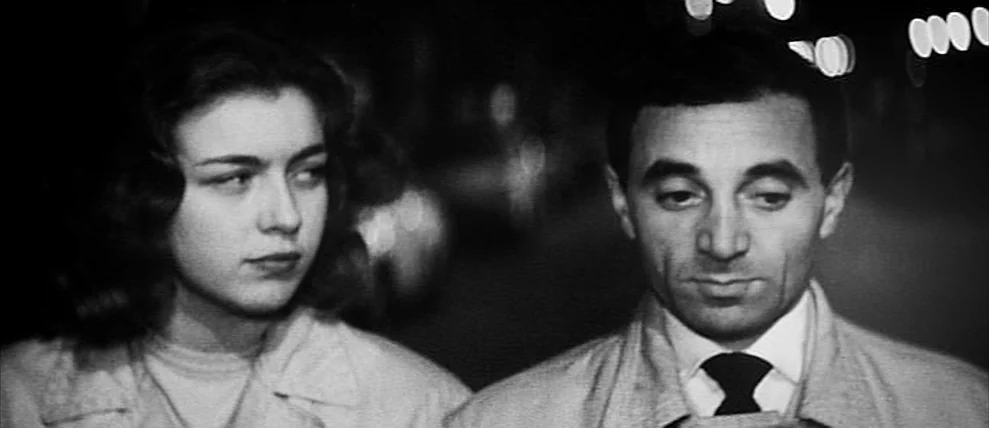 Shoot The Piano Player (Tirez Sur Le Pianiste) (1960) movie still: medium — An outdoor urban street at night with blurry street lights in the…