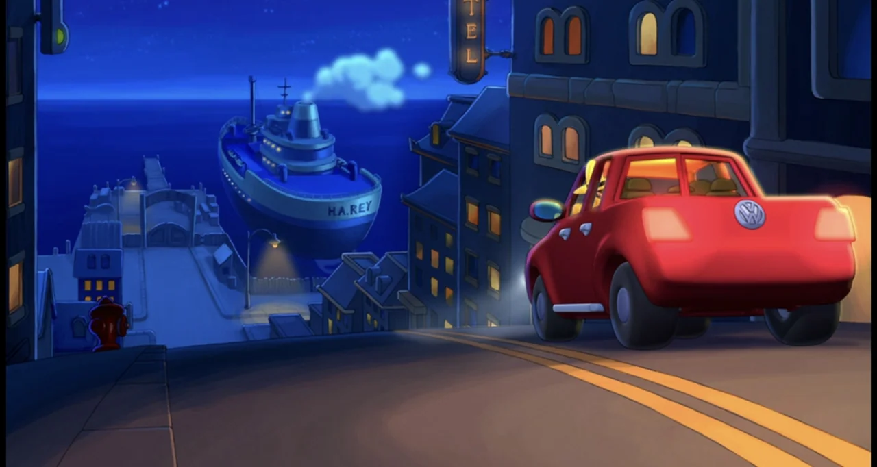Curious George (2006) movie still: wide — A nighttime coastal street slopes downward toward a harbor featuring a docked blue cargo ship. A red car…