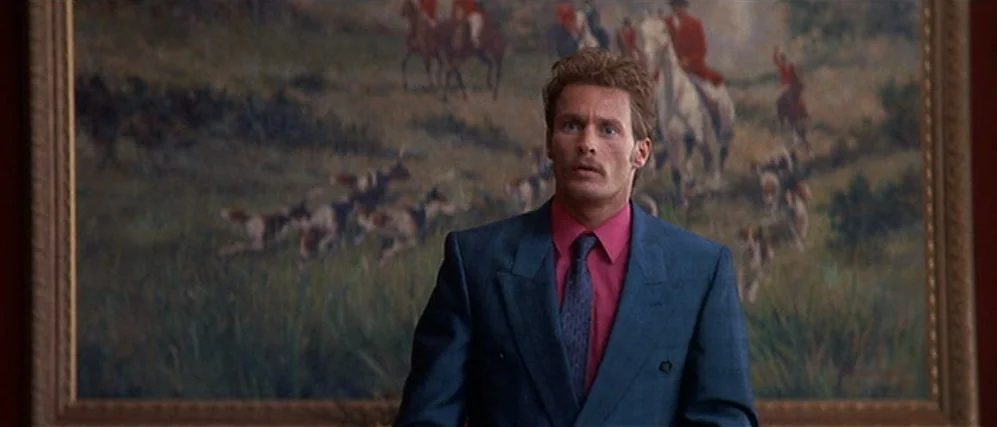 The People vs. Larry Flint (1996) movie still: medium — A man stands in front of a large, framed hunting landscape oil painting. He stares forward…