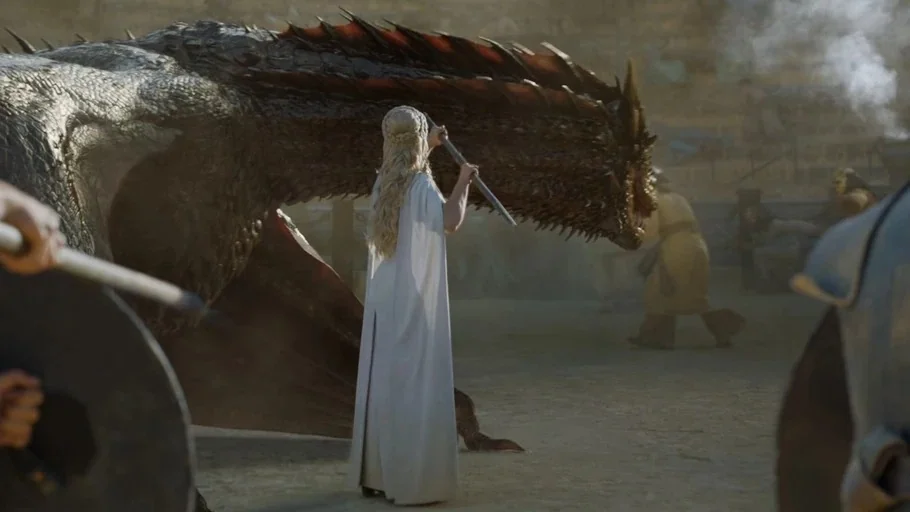 Game of Thrones (2015) movie still: fullbody — A dusty outdoor arena with sand underfoot and tiered seating visible in the distance. A woman in a…