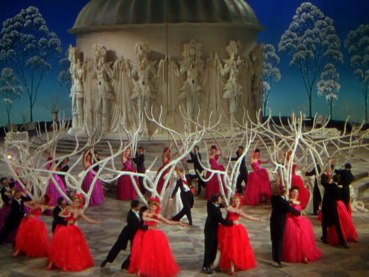 Ziegfeld Follies (1945) movie still: wide — A grand outdoor plaza with a large domed architectural structure featuring ornate stone relief carvings.…