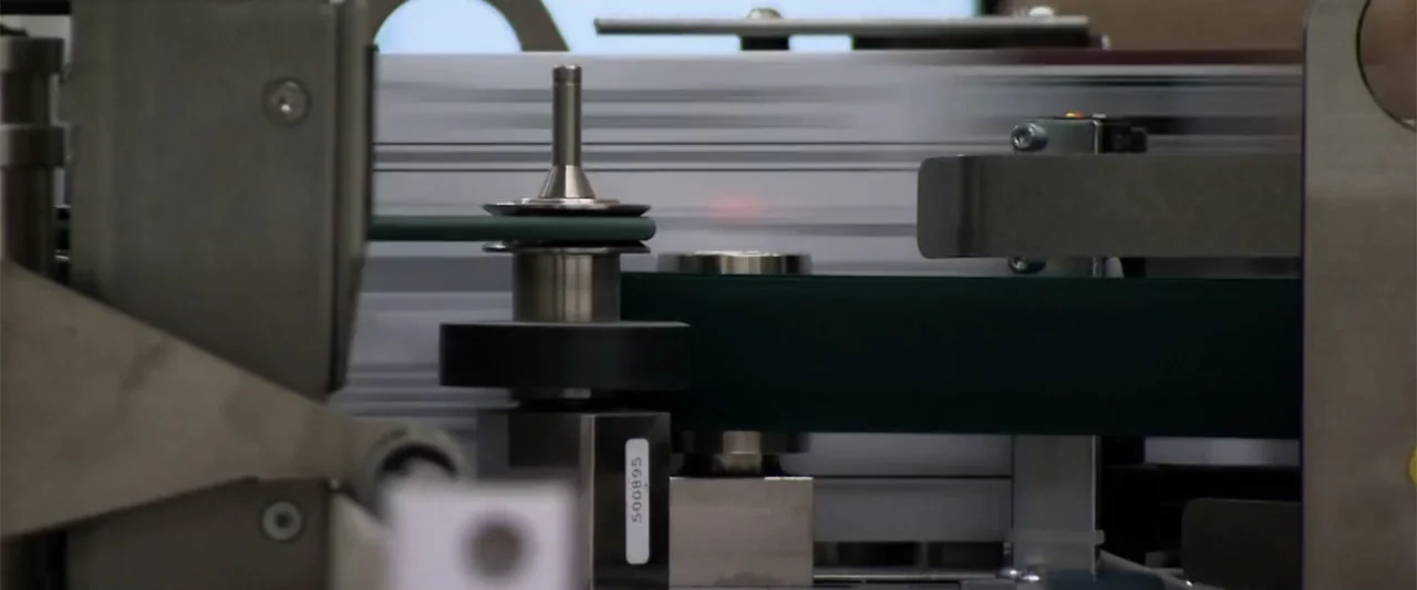 All In: The Fight for Democracy (2020) movie still: closeup — Industrial printing equipment with dark green belts and metal rollers operates in a…